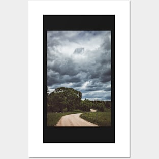 Country road under dark cloudy sky Posters and Art